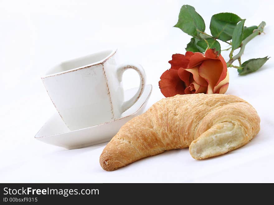 Croissant, cup of caffee on white background