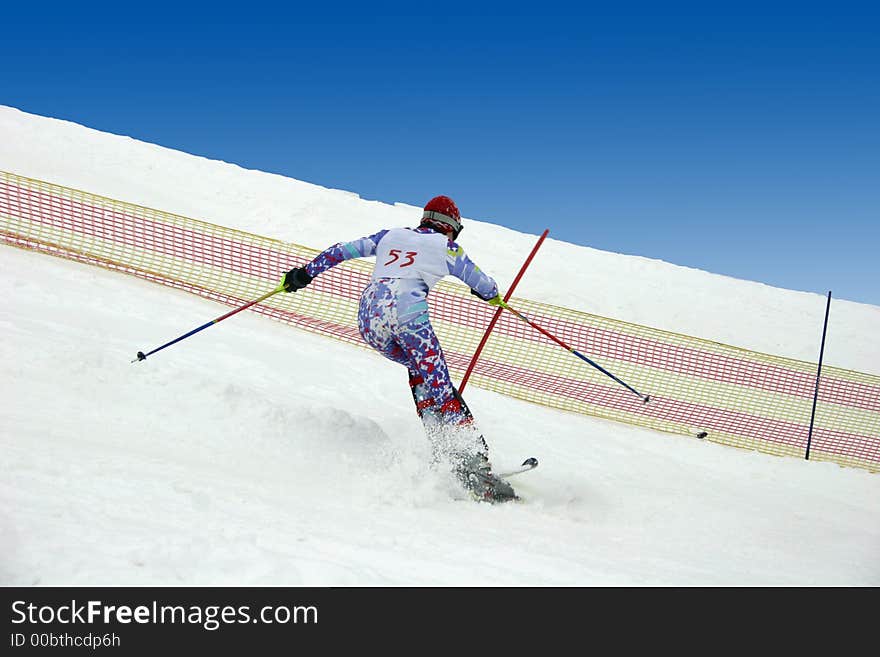 Young skier doing downhill slalom. Young skier doing downhill slalom