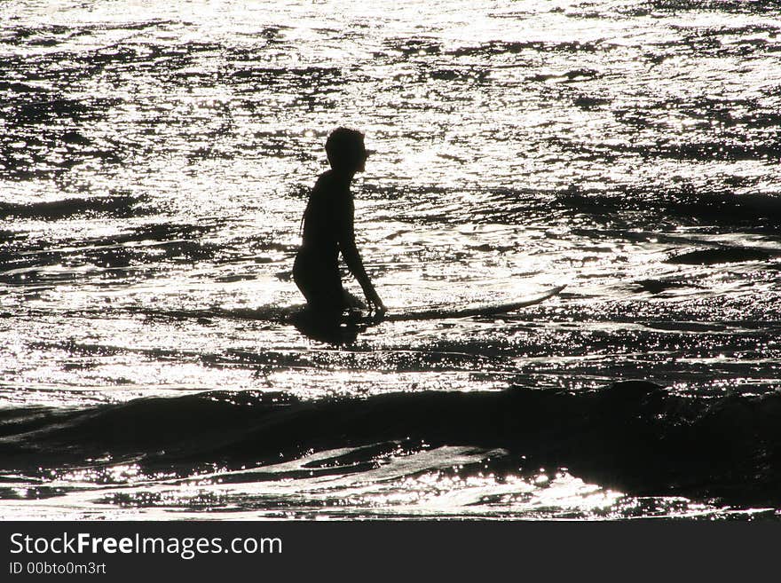 Surfer and board silhouette entering the ocean. Surfer and board silhouette entering the ocean