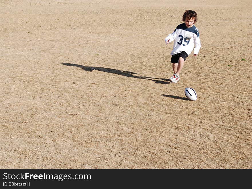 Football chasing boy