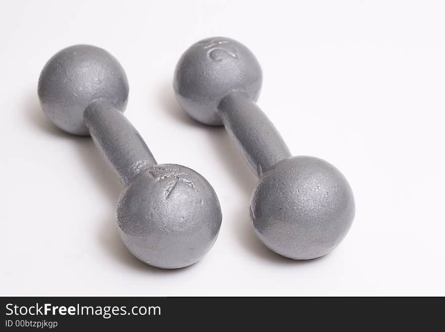 Two weights laying on a white background