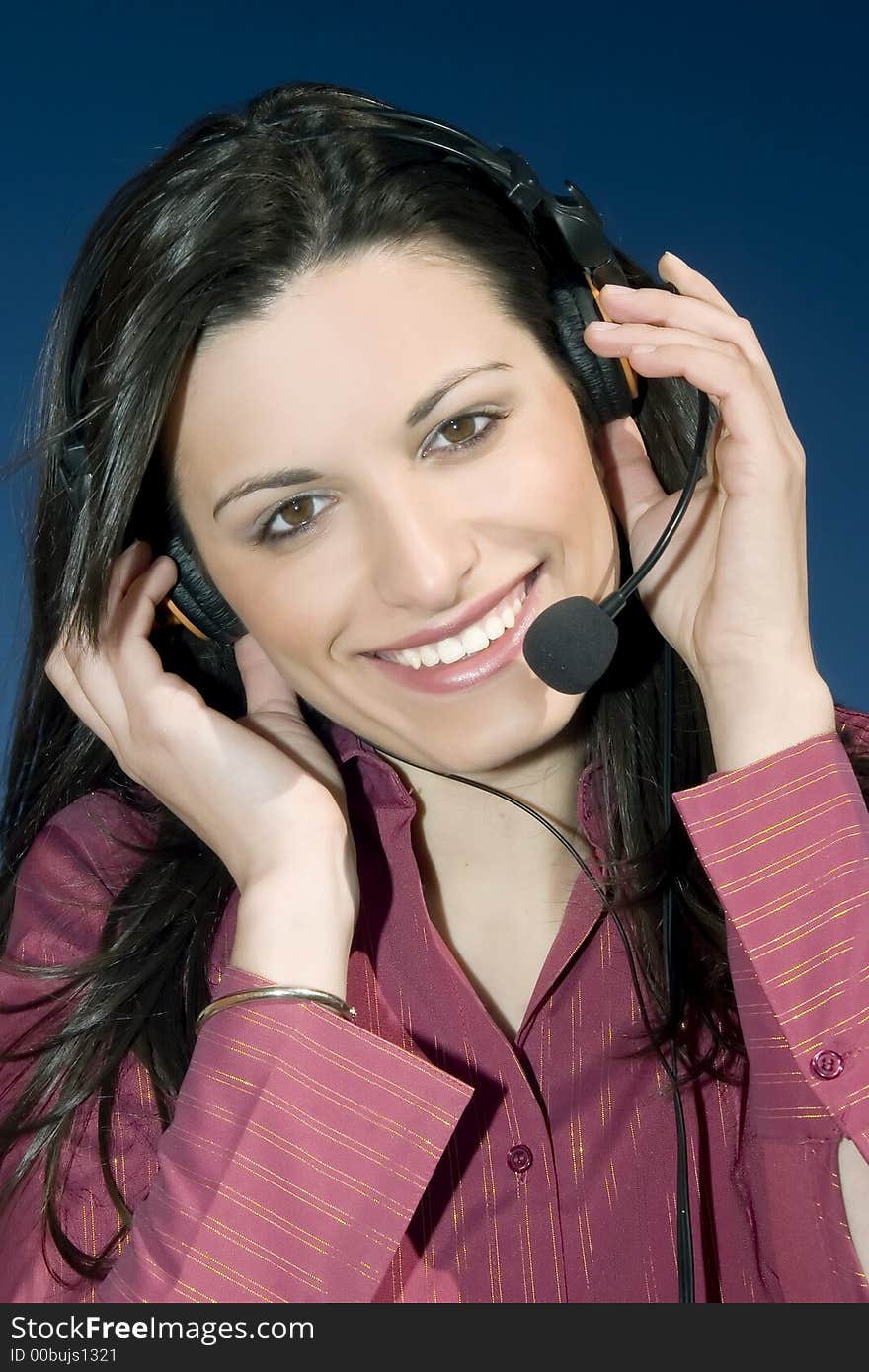 Smiling young woman of a call center, on blue background. Smiling young woman of a call center, on blue background