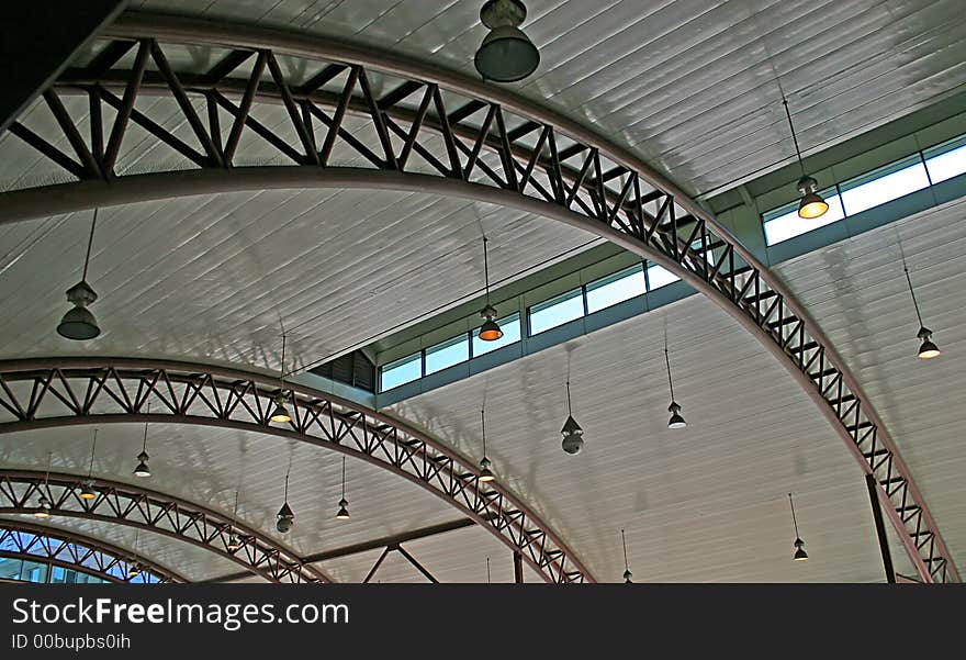 Steel arches supporting curved concrete roof