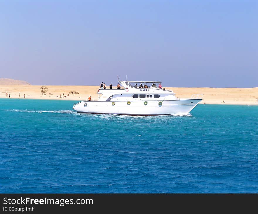 Bright wight yacht is sailing on the Red Sea with tourist's group. Bright wight yacht is sailing on the Red Sea with tourist's group