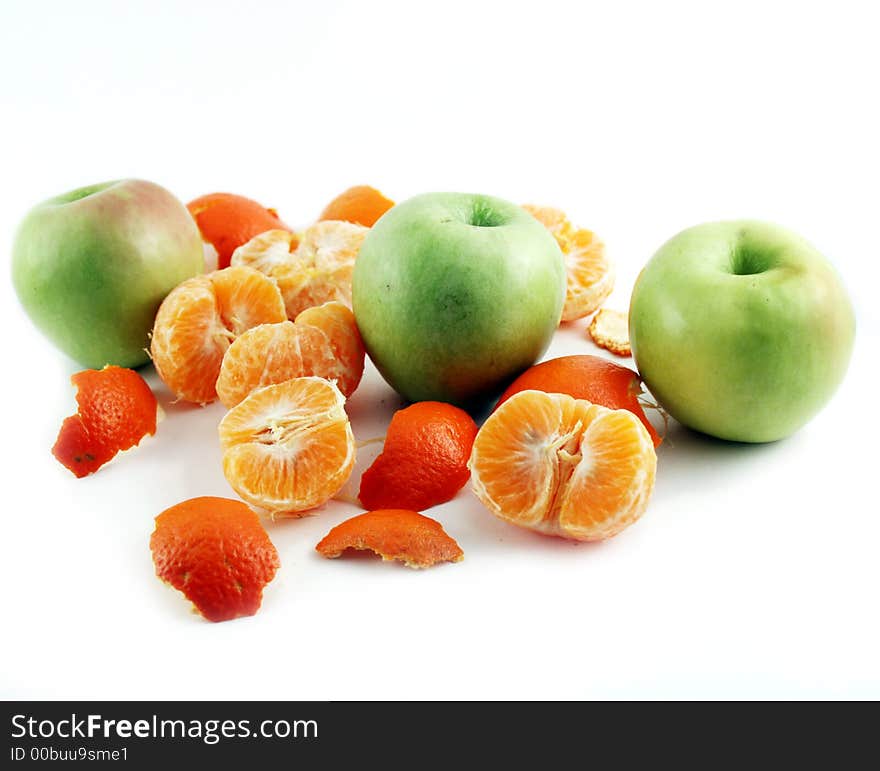 Peeled mandarin and apples isolated on white background