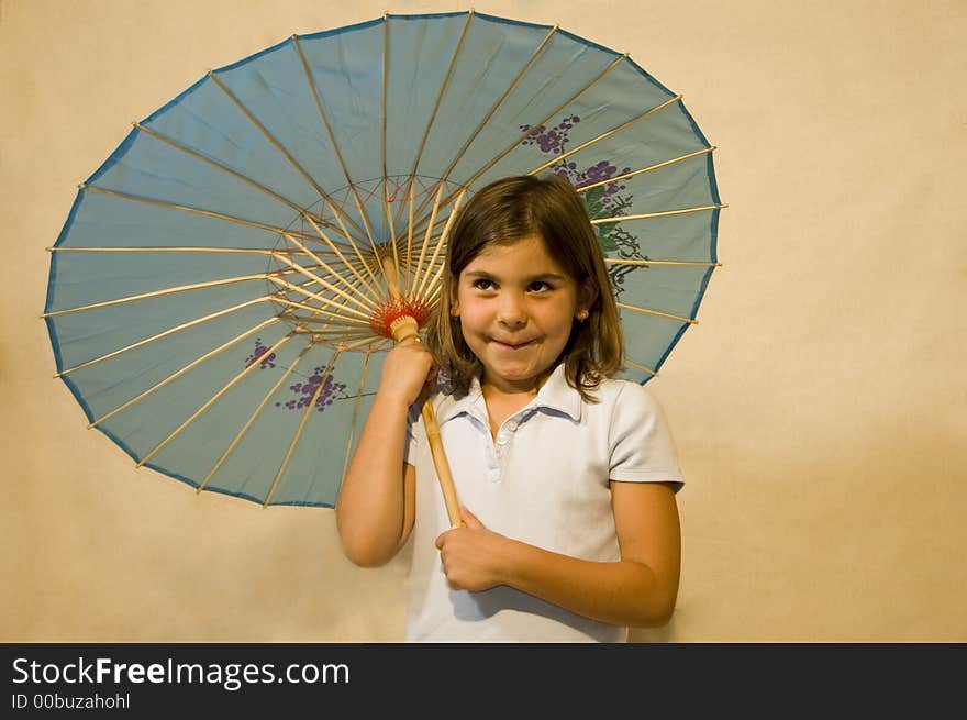 Girl holding a blue parasol/umbrella. Girl holding a blue parasol/umbrella