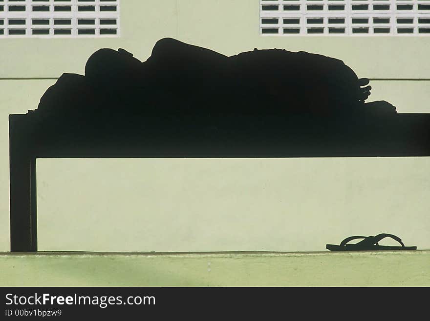 A Buddhist monk takes an afternoon sleep in a temple, Thailand. A Buddhist monk takes an afternoon sleep in a temple, Thailand