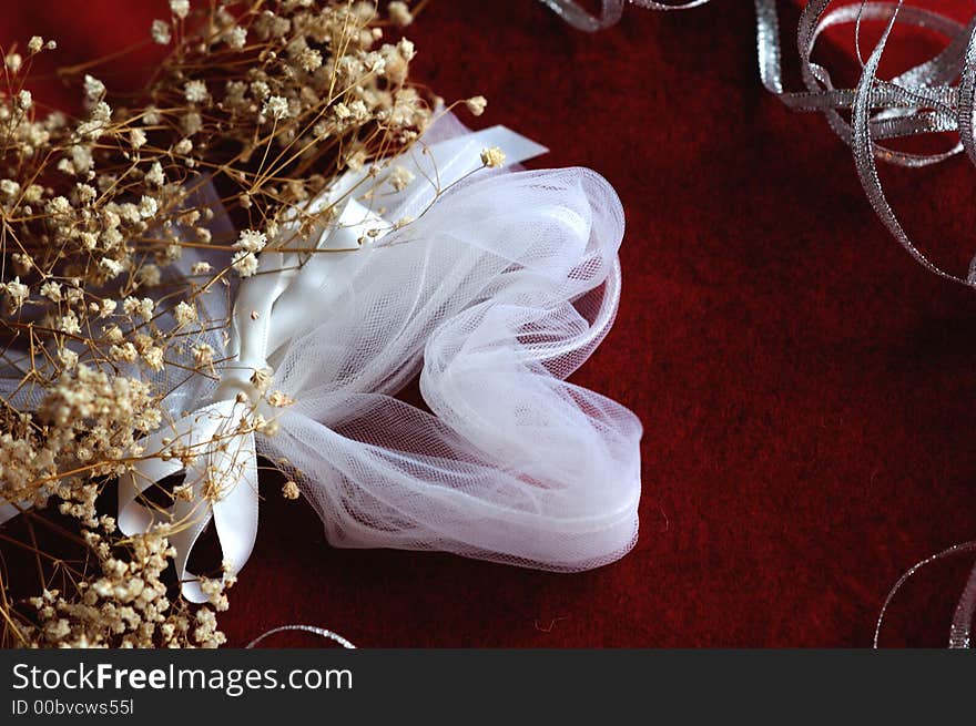 White heart against a red background with baby's breath in foreground. White heart against a red background with baby's breath in foreground