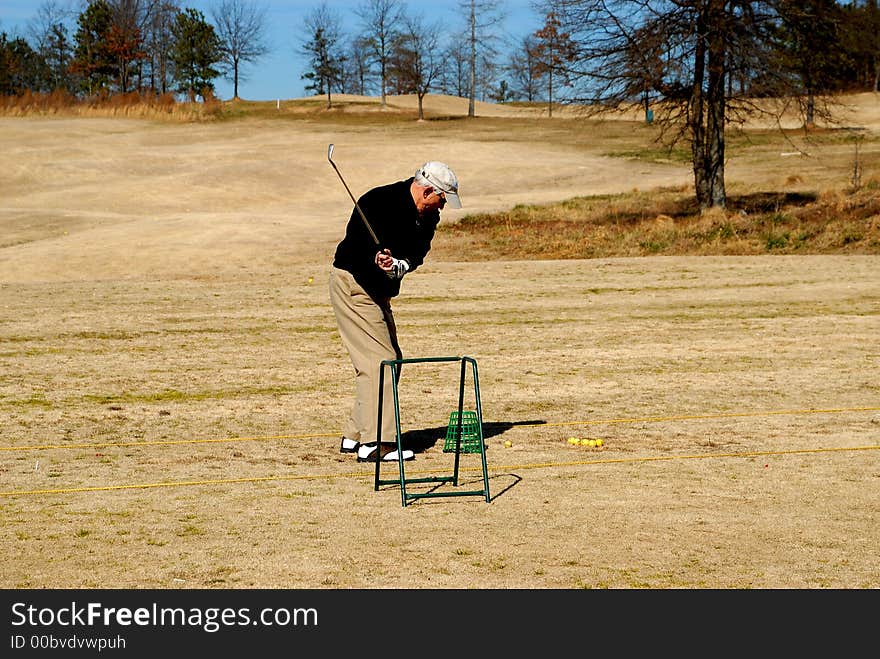 Photographed senior citizen golfer at local course in Georgia. Photographed senior citizen golfer at local course in Georgia.