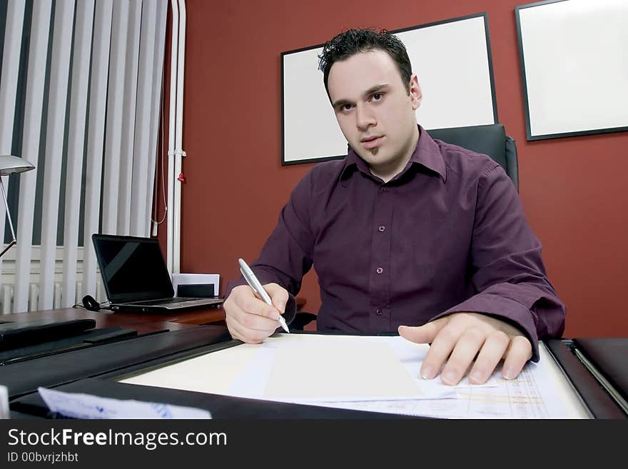 Businessman in his office writing document