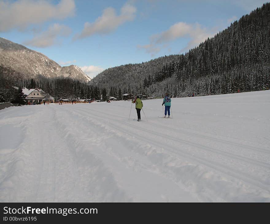 Beautiful winter landscape showing a cross-country ski run with people skiing