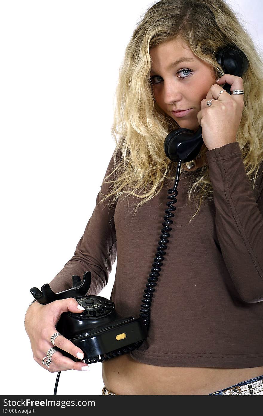 Young sexy blond woman with a telephone in hand. Young sexy blond woman with a telephone in hand