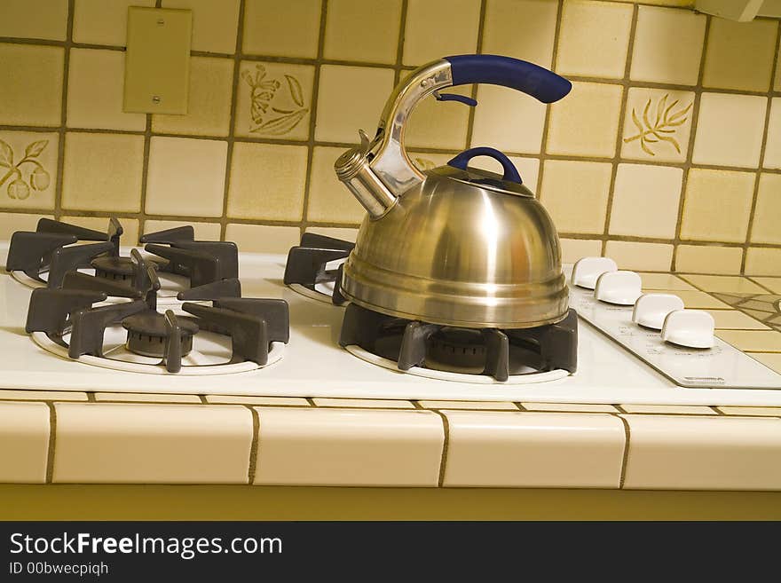 Kettle on an old stove burner boiling water for tea. Kettle on an old stove burner boiling water for tea.