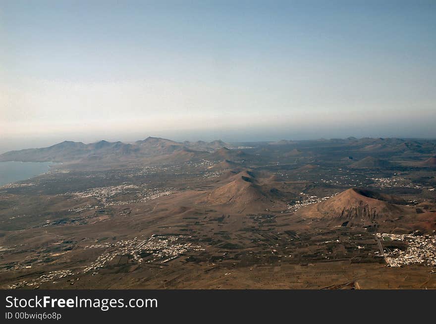 Volcano field and a ridge of land with more volcanos in the distance Timanfaya Lanzarote. Volcano field and a ridge of land with more volcanos in the distance Timanfaya Lanzarote