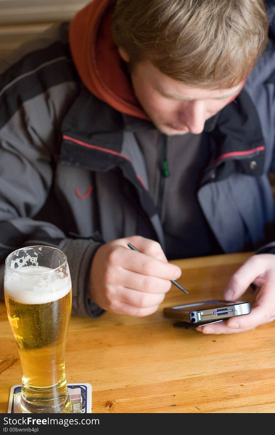 Man With Beer And Palm-size Computer