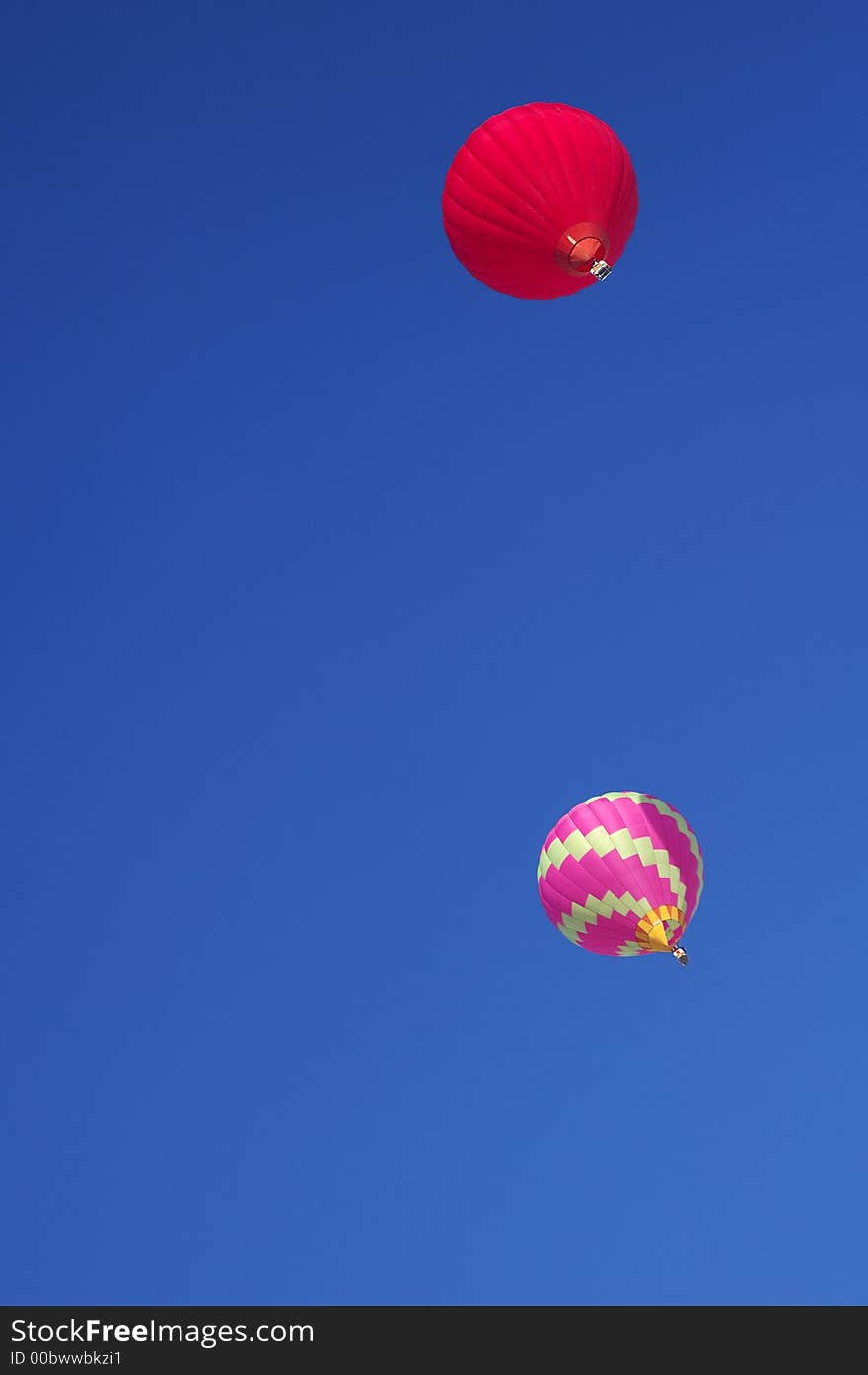 Two hot-air balloon floating high in a clear blue sky. Two hot-air balloon floating high in a clear blue sky.