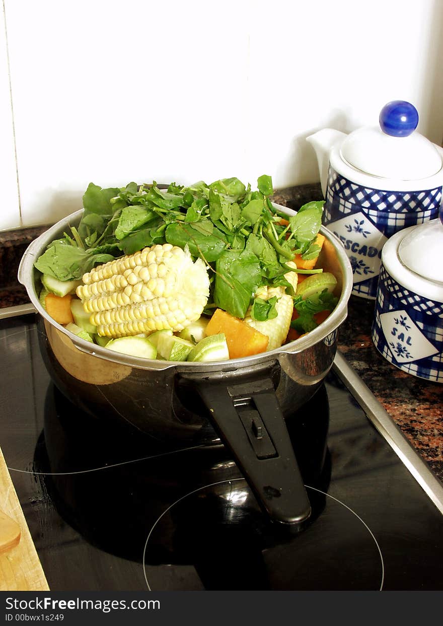 Preparing a vegetables soup in the pressure cooker on the kitchen