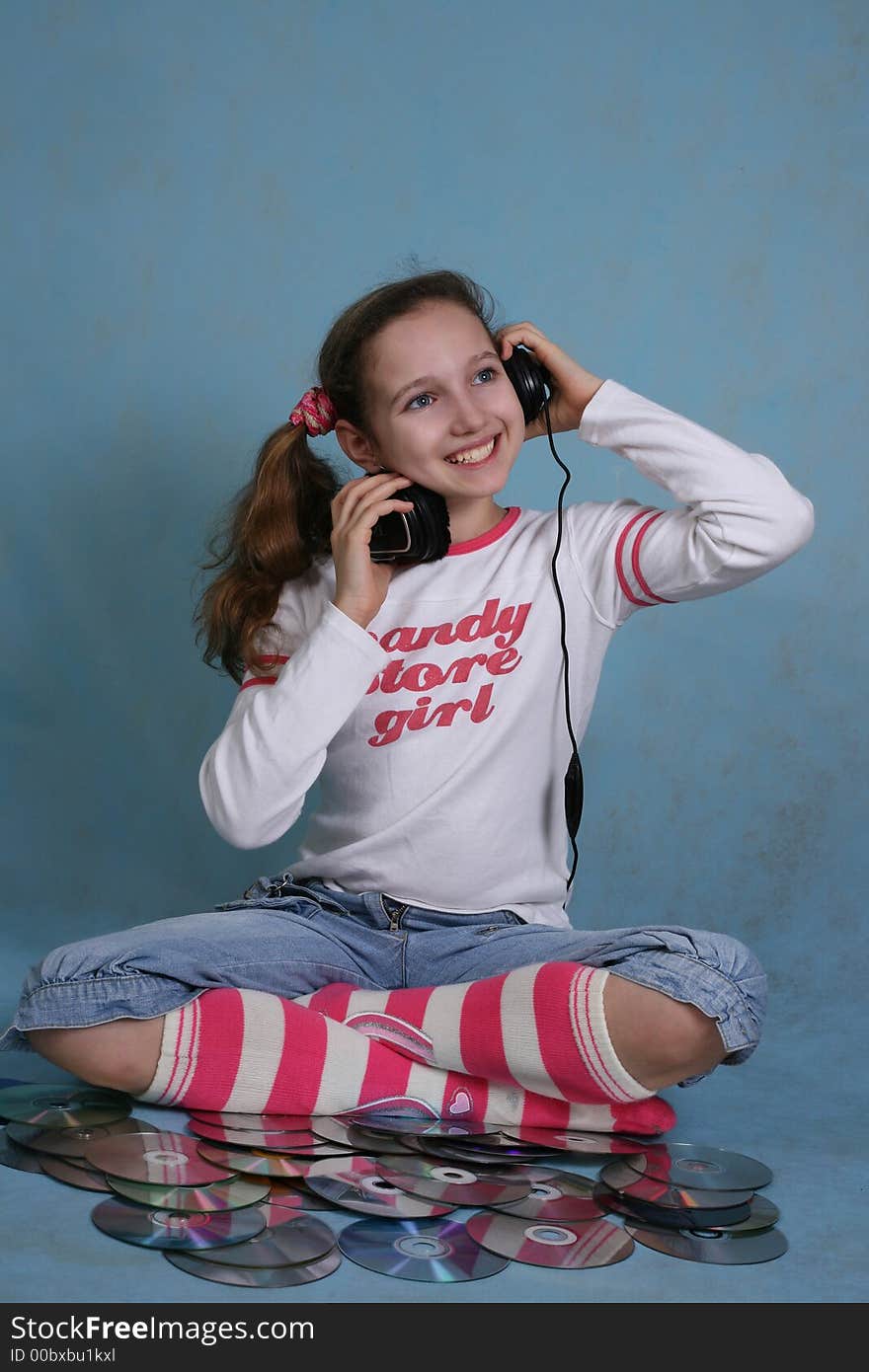 Smiling girl in headphones on a blue background