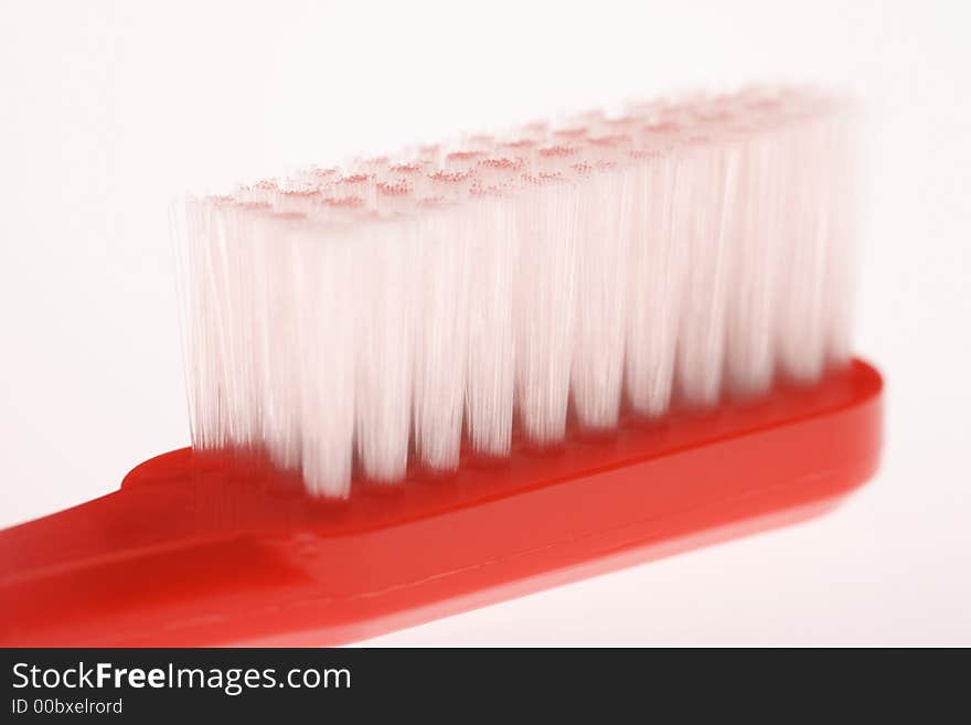 Red toothbrush with white bristles