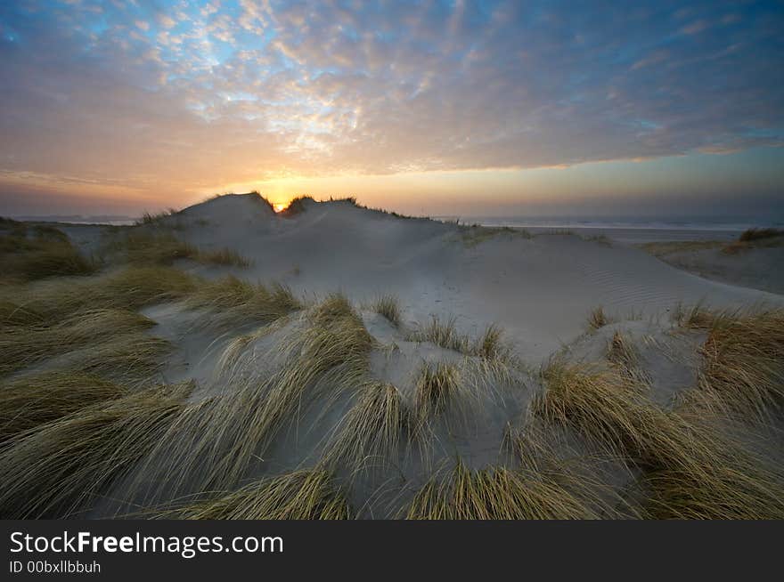 Beautiful sunset , sand dunes and ocean. Beautiful sunset , sand dunes and ocean