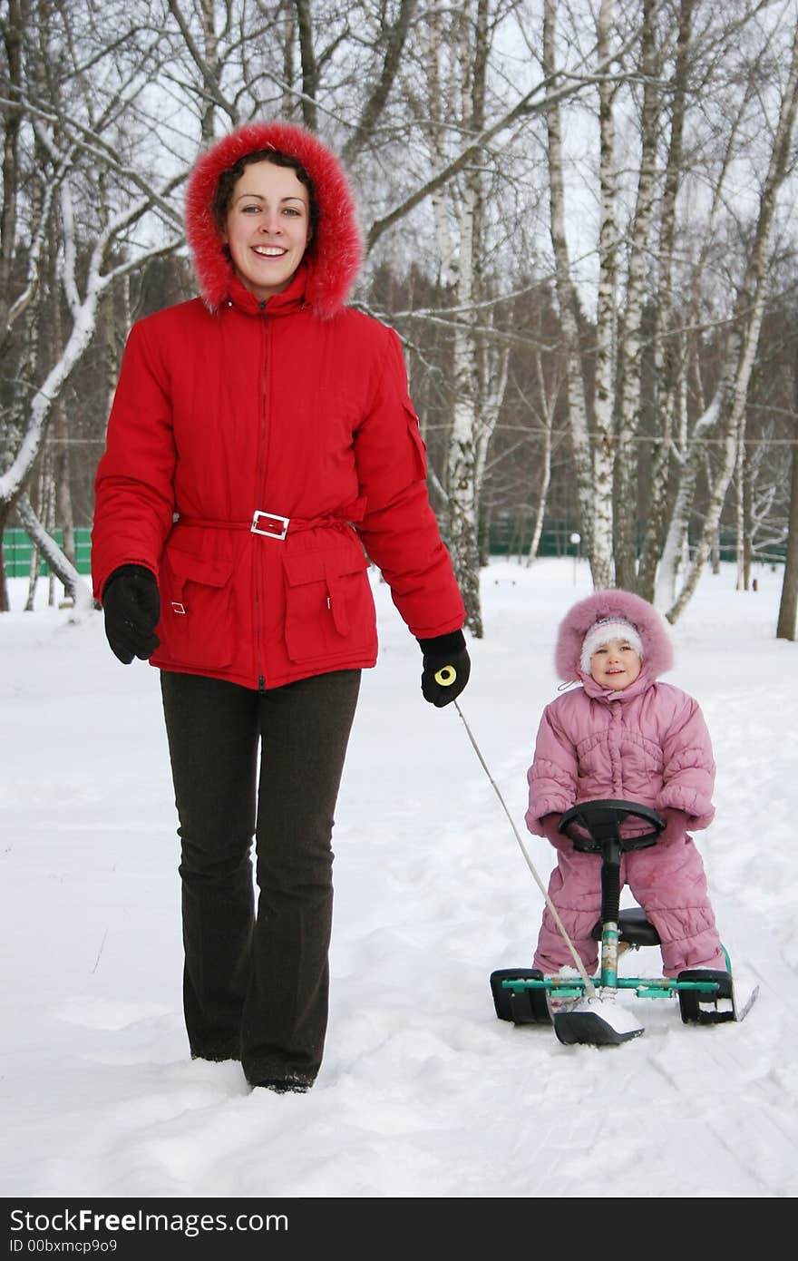 Mother with baby on sled