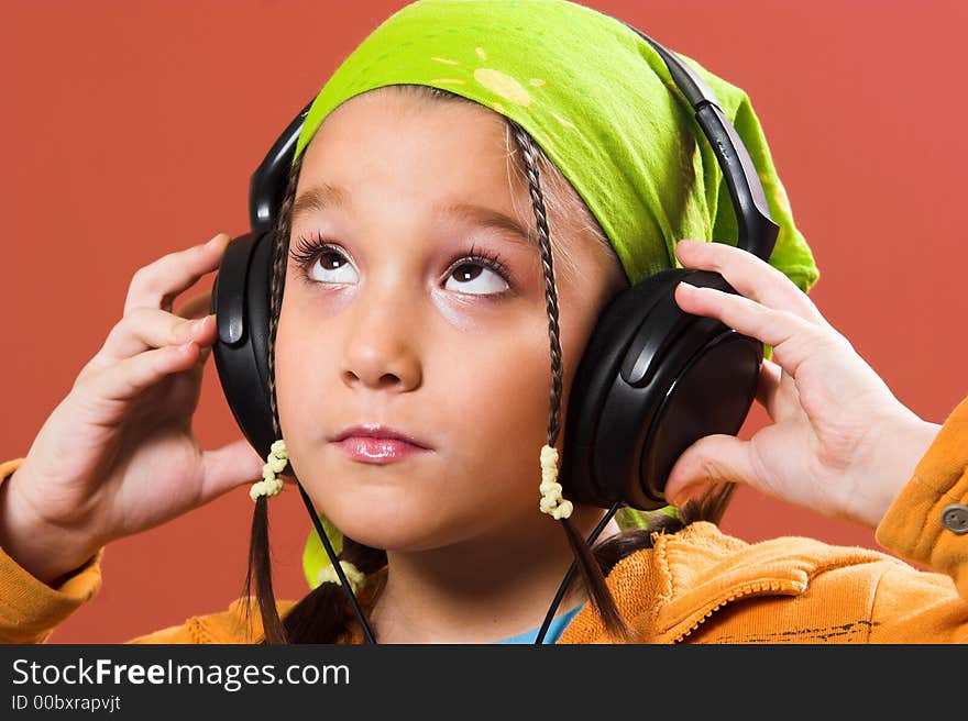 Child listening music in headphones