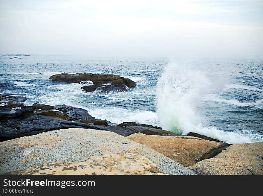 Choppy waves and seaspray on a hazy coast. Choppy waves and seaspray on a hazy coast.