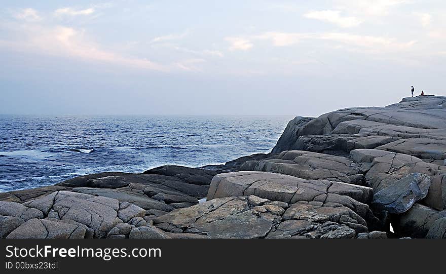 Huge rocks on the coast that dwarf the tourists. Huge rocks on the coast that dwarf the tourists.