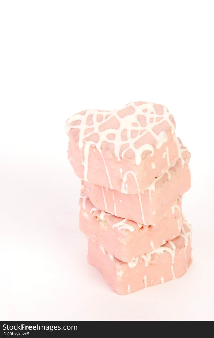 Stack of four pink heart snack cakes with white frosting. Stack of four pink heart snack cakes with white frosting