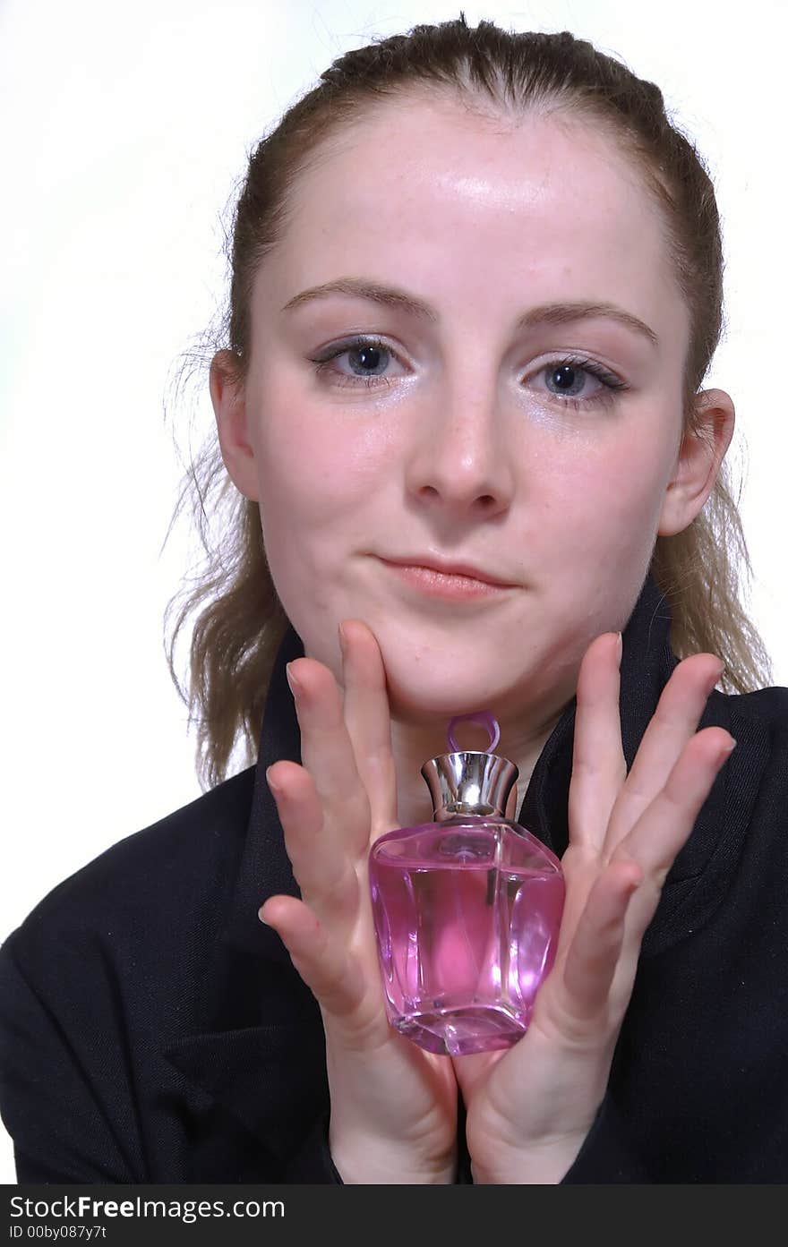 The girl with a bottle of perfume in the hand