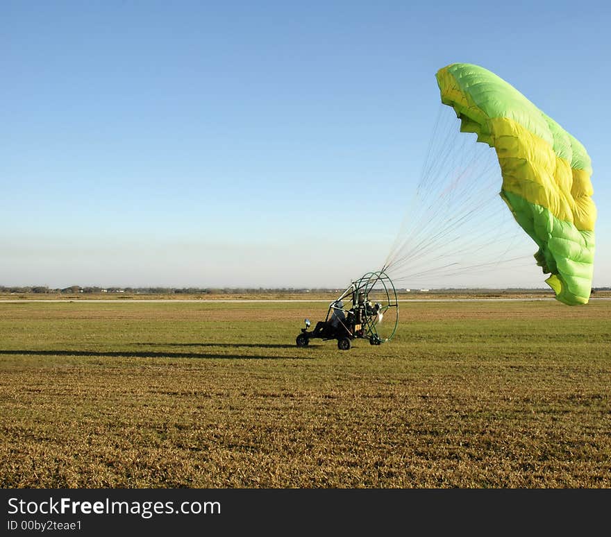 Paraglider touching down after a flight. Paraglider touching down after a flight.