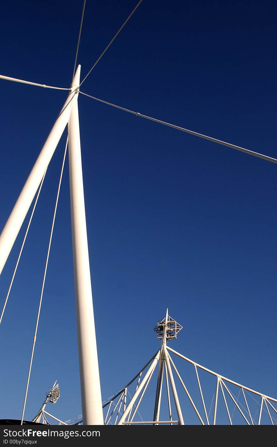 A bridge with football floodlights in the background. A bridge with football floodlights in the background