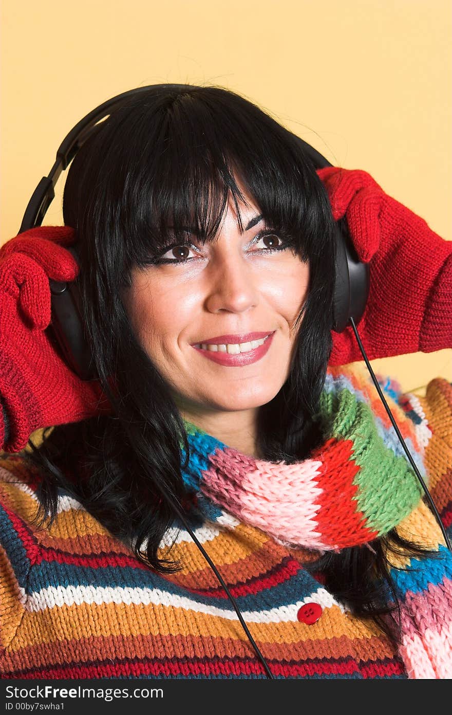 Beautiful woman listening music in headphones