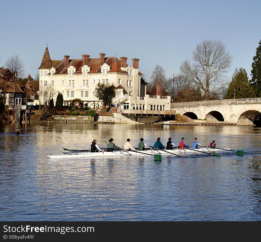 Winter scene of an Historic Road Bridge over the River Thames in England with a racing rowing boat in the foreground. Winter scene of an Historic Road Bridge over the River Thames in England with a racing rowing boat in the foreground.