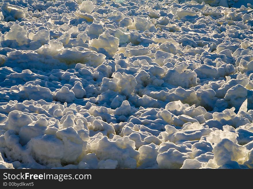 Close-up of chaotic ice floe and snow floating on a river. Close-up of chaotic ice floe and snow floating on a river