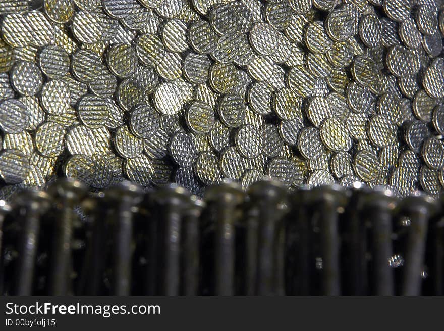 A large number of nails being reflected off of a mirror. A large number of nails being reflected off of a mirror.