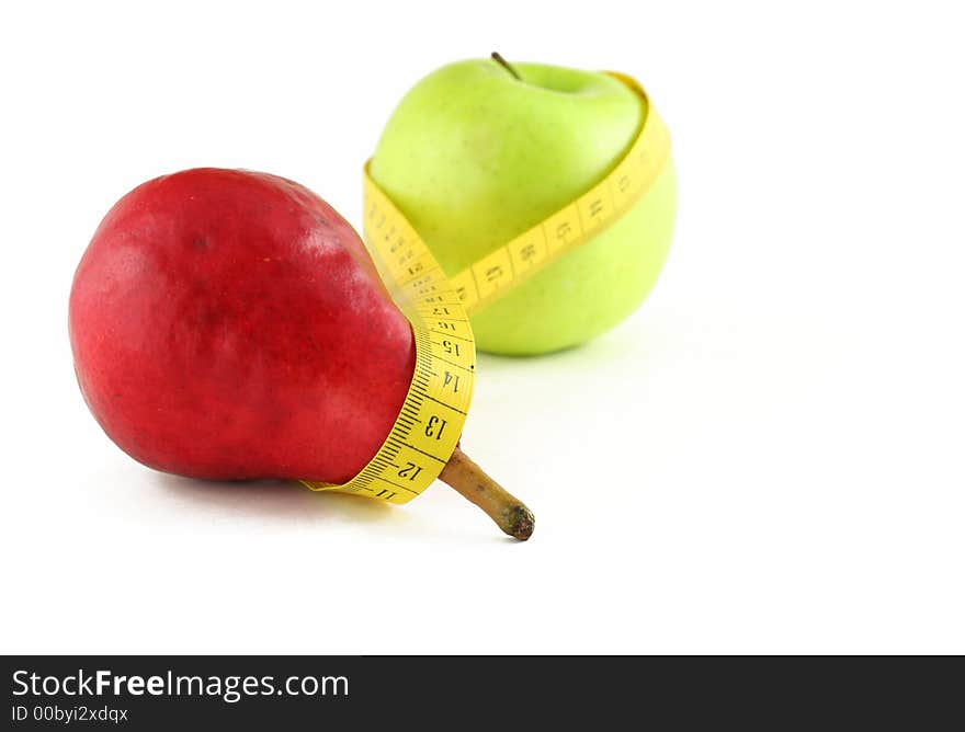 Red pear and green apple joint by measuring tape, isolated on white