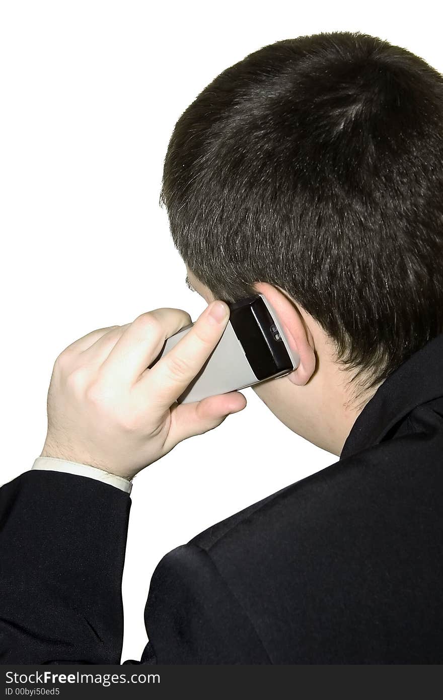 A young man talking on a cellular phone on a white background