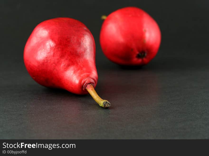 Red pears on dark background, narrow focus