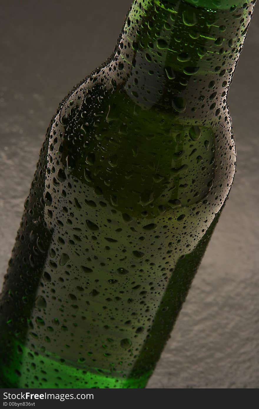 A moody shot of a bottle of beer. A moody shot of a bottle of beer