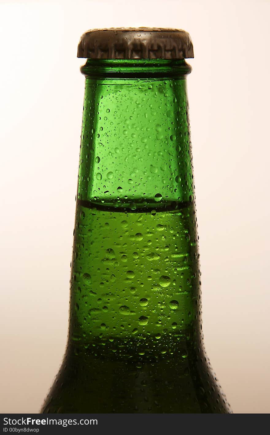 A shot of the neck of a cold bottle of beer. A shot of the neck of a cold bottle of beer