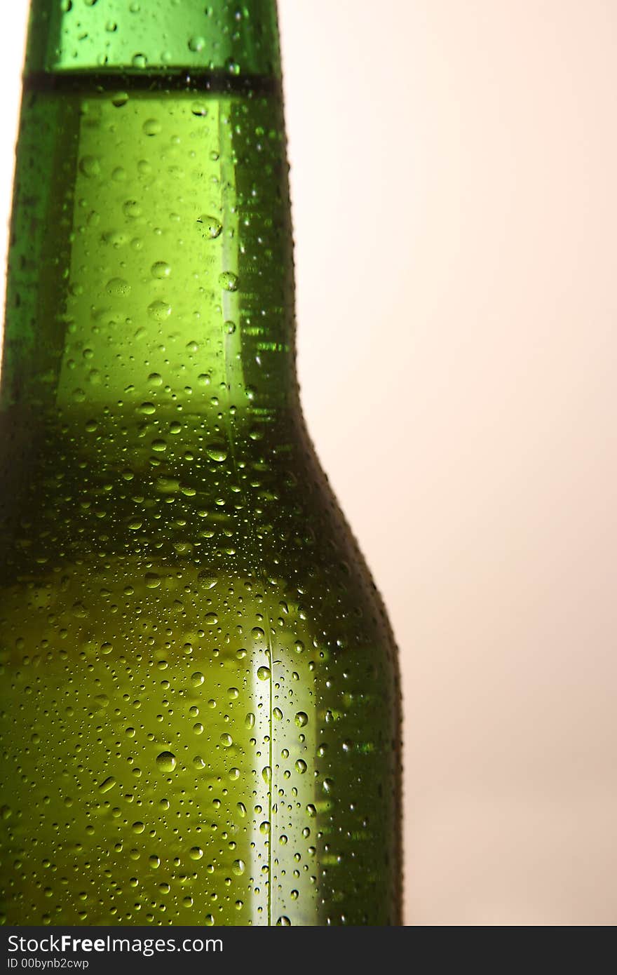 The neck of a cold bottle of beer. The neck of a cold bottle of beer