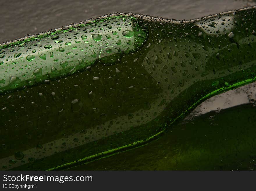 A cold bottle of beer laying down on a slate base. A cold bottle of beer laying down on a slate base