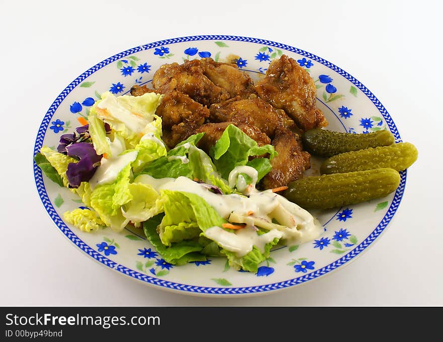 Photo of chicken bbq on a plate together with salad and dressing. Photo of chicken bbq on a plate together with salad and dressing