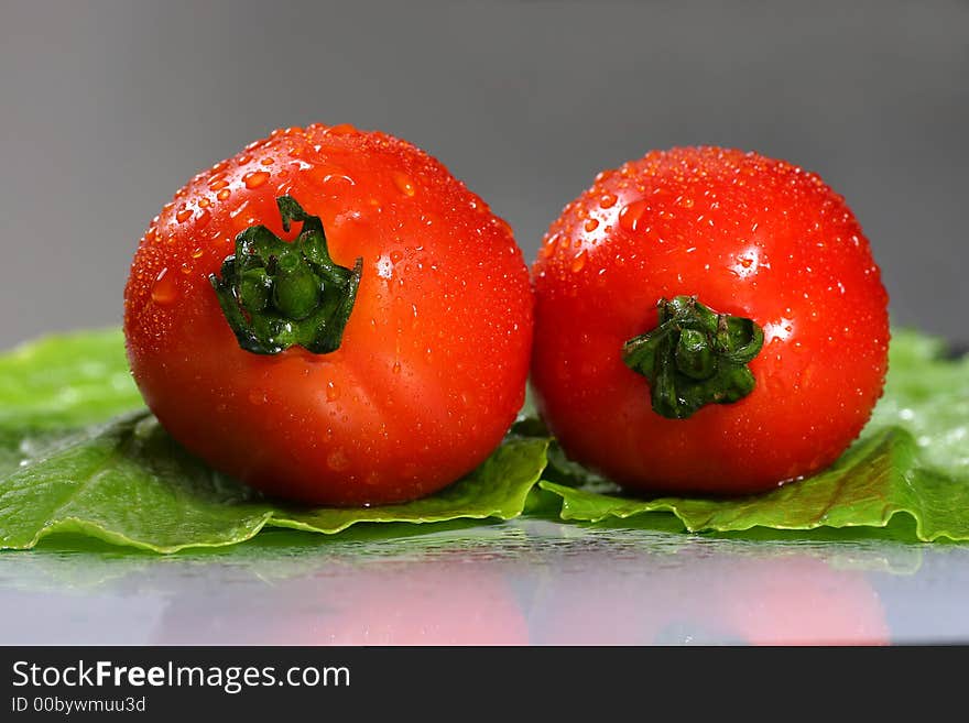 Fresh Couple Tomato On The Green Colza Background