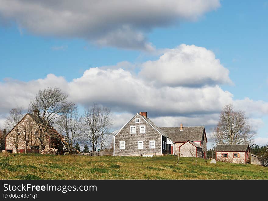 Farmland scenic with a house and other buildings. Farmland scenic with a house and other buildings