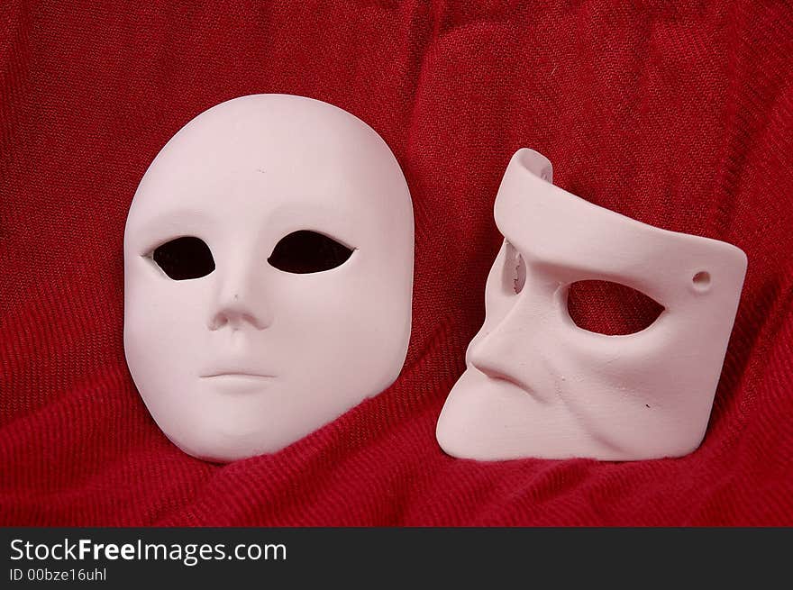 Couple of Venice carnival mask on red sheet