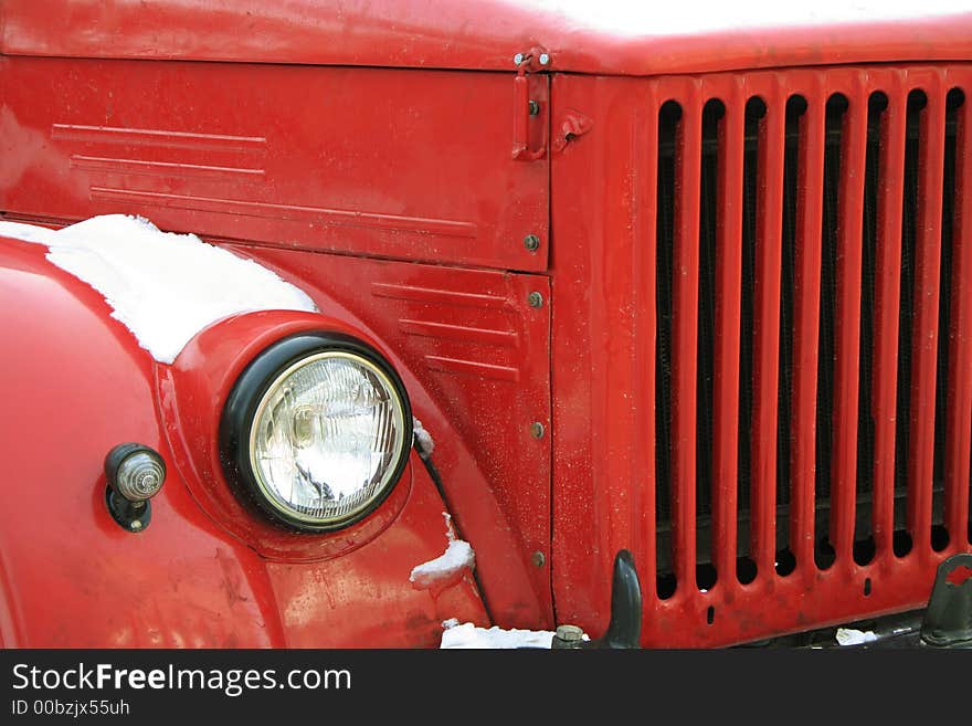 The red old car under a snow