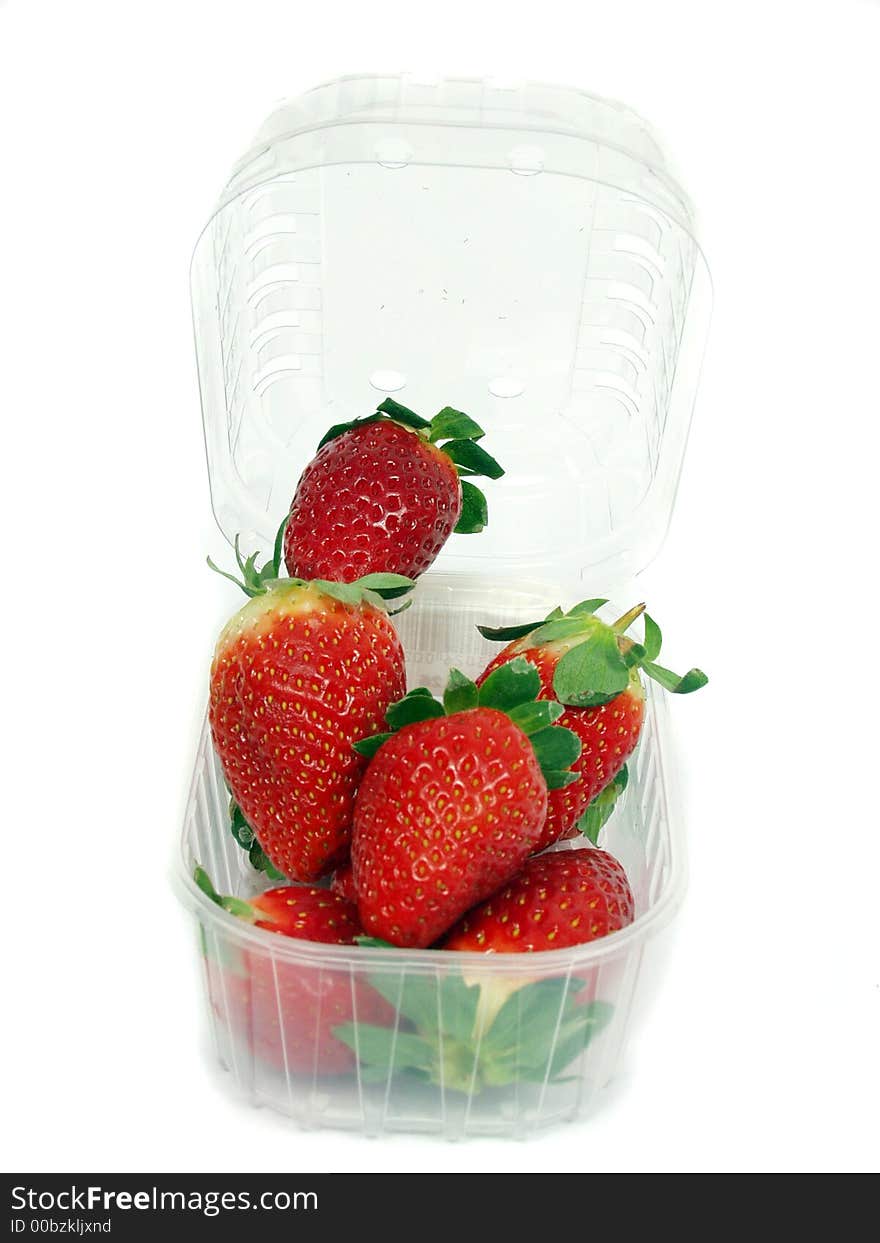 Fresh red strawberry on plastic box on white background