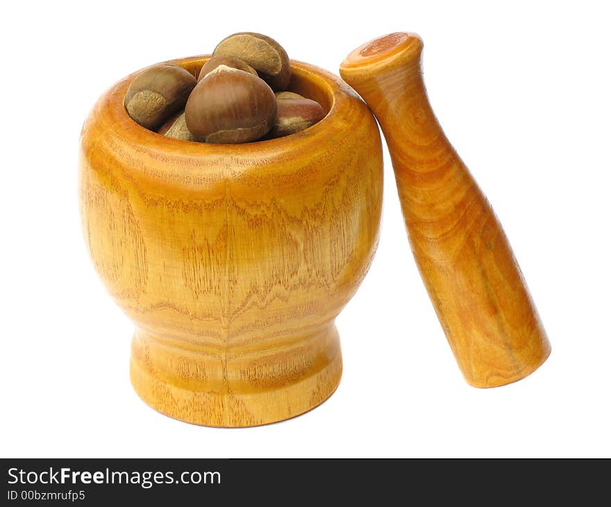 Wooden  mortar with pestle standing outside and chestnuts in the bowl on white background. Wooden  mortar with pestle standing outside and chestnuts in the bowl on white background